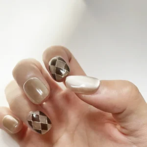 Coffee brown and nude cat eye press-on nails with argyle pattern on right hand