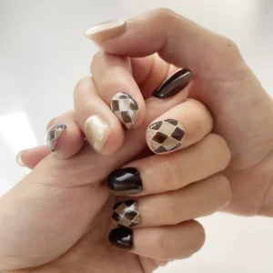 Chocolate coffee brown and nude cat eye press-on nails with argyle pattern on finger