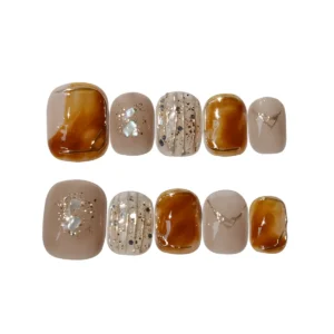 Amber tortoiseshell and nude press-on nails with gold detailing and pearl shimmer – short fake nails with marble effect