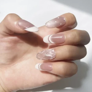 Left hand modeling soft pink cat eye press-on nails with quilted and polka dot accents