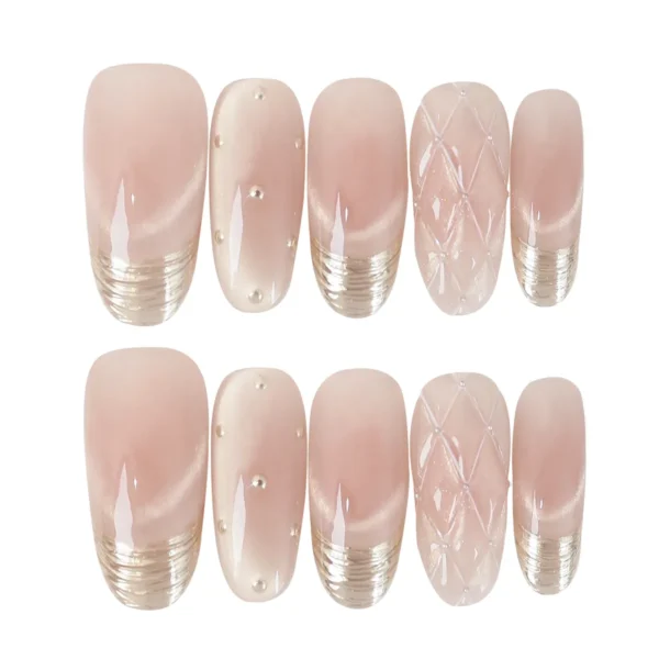 Rose gold-pink cat eye press-on nails with gold French tips, quilted and polka dot accents – long oval fake nails