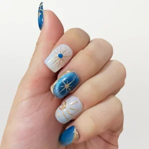 Hand wearing blue celestial cat eye medium squoval fake nails