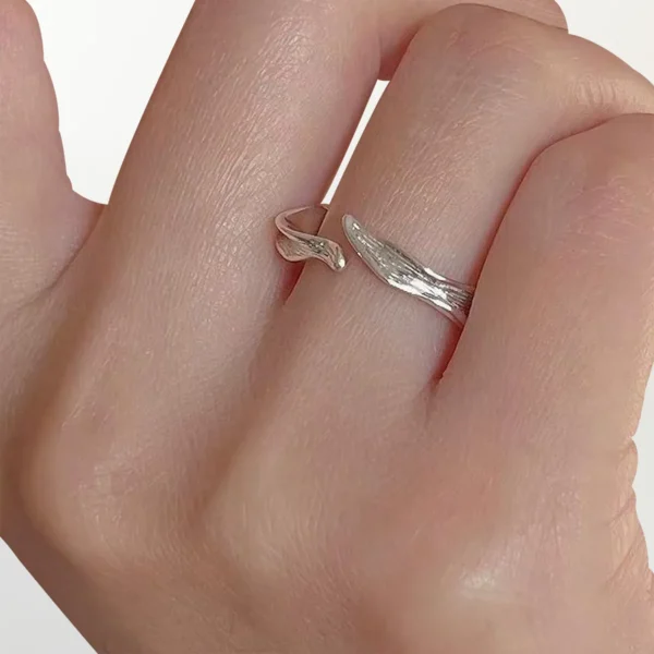 Hand wearing adjustable sterling silver wave ring with textured design